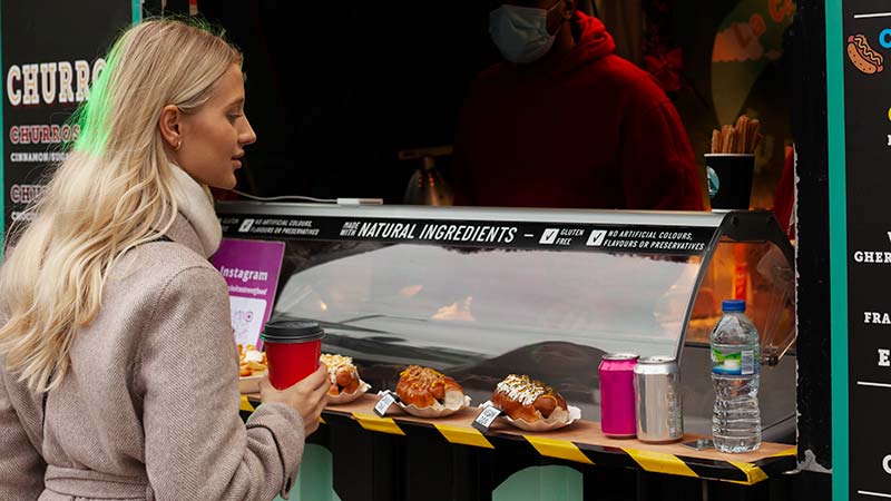 Woman-eating-at-airstream-food-trailer